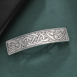 Vintage silver hair clip with rectangle Celtic knot and raven motif on dark background