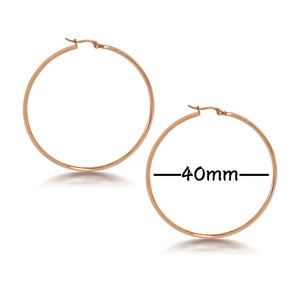 Detail of 40mm rose gold geometric hoop earrings with high polish finish and click closure
