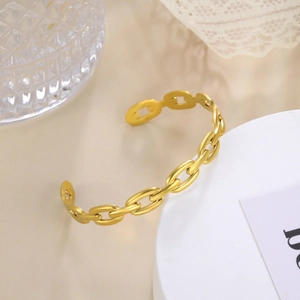 Detailed close-up of a gold-plated oval chain link open cuff bracelet for women