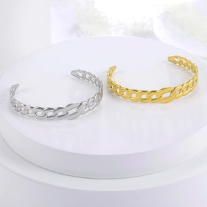 Detail of gold and silver plated cutout link bracelets on white minimalist display