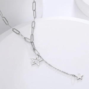 Detail of silver Y-shape necklace with paperclip chain and double star pendants