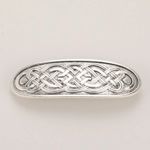 Macro shot of silver retro Celtic knot rectangular hair clip with intricate embossed texture