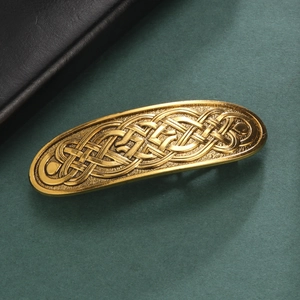 Vintage gold Celtic knot metal hair clip for women with an elegant braided texture
