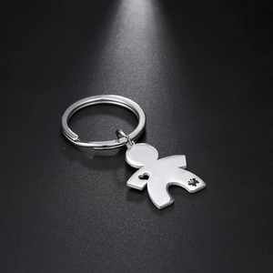 Macro shot of silver stainless steel figurine keychain with hollow heart and butterfly detail