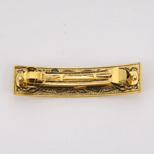 Vintage gold alloy hair clip with embossed floral patterns and spring back closure