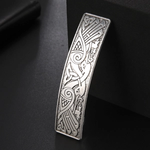 Detail of vintage silver hair clip featuring Celtic knots and twin crane engraving