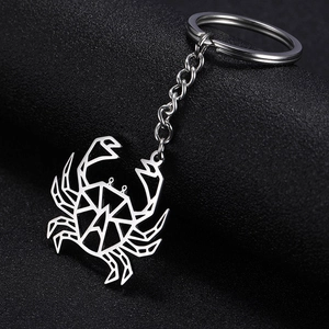 Polished stainless steel keychain featuring a hollow origami crab pendant on black texture