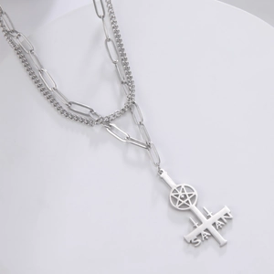 Detail of silver double layer necklace with inverted cross and star pendant