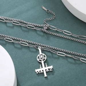 Detail of silver stainless steel double chain with inverted cross and pentagram pendant