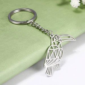 Polished silver stainless steel keychain featuring a geometric hollow toucan bird charm