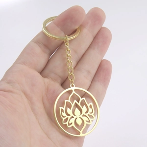 Minimalist gold stainless steel keychain featuring a hollow lotus flower circle pendant