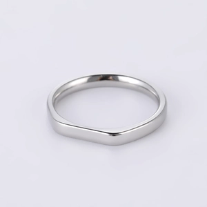 Macro shot of silver geometric square-round stainless steel ring with polished flat surface