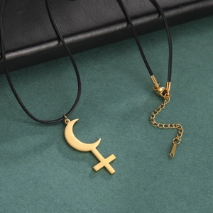 Detailed view of golden Lilith pendant with crescent moon and cross on black waxed cord