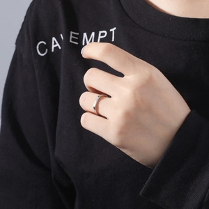 Polished silver wave ring for women shown as a minimalist index finger band