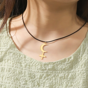 Minimalist gold Lilith crescent moon cross necklace with black cord worn by a model