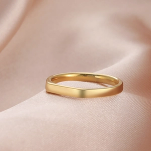Minimalist geometric gold titanium steel ring displayed on soft pink silk fabric