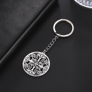 Minimalist silver stainless steel keychain with hollow spiral scroll pattern on black leather