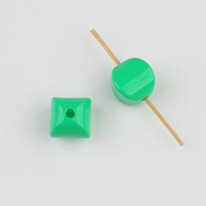 Macro detail of green square acrylic beads with vertical holes for DIY jewelry making