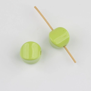 Detail showing light green acrylic square beads with a center hole for DIY jewelry