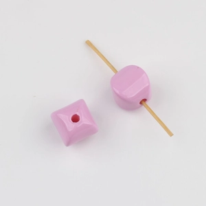 Detail of pink acrylic square bead with vertical hole for DIY jewelry making