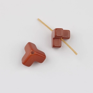 Close-up of reddish-brown acrylic star beads showing central hole for DIY jewelry making