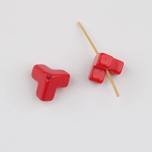 Macro detail of red triangle acrylic beads with glossy finish for DIY jewelry crafts