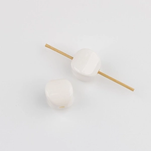 Macro detail of white acrylic square beads with vertical holes for DIY jewelry making