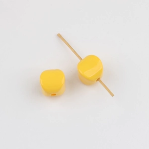 Detail of bright yellow acrylic vertical hole spacer beads for DIY jewelry making