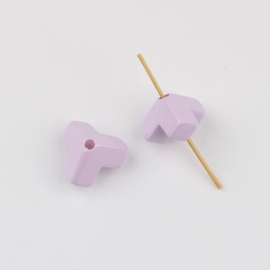 Close-up of matte lavender triangle beads for DIY crafts showing functional center hole