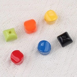 Macro shot of colorful acrylic cube beads with vertical holes for DIY jewelry making