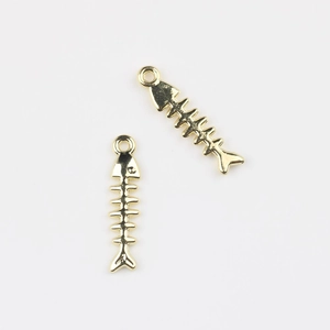 Detailed view of two polished gold fishbone pendants for DIY jewelry crafting