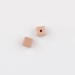 Detailed macro view of square acrylic beads in nude pink for DIY jewelry crafting