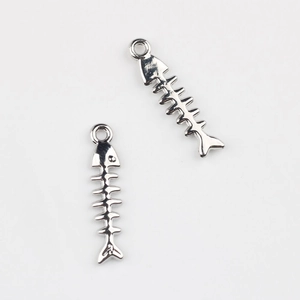 Macro shot of silver fish bone pendants for DIY jewelry with detailed metallic texture