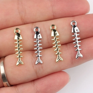 Set of four gold and silver fishbone metal alloy pendants for DIY jewelry making