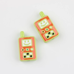 Macro detail of two colorful retro walkie-talkie acrylic beads for DIY jewelry making