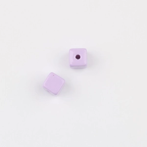 Close-up of small lilac acrylic cube beads with smooth surface for DIY jewelry making
