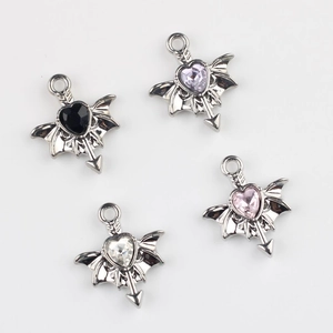 Macro detail of four gothic wing heart gemstone pendants for DIY jewelry making