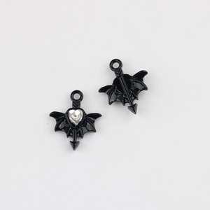 Macro view of black bat wing heart pendant with sparkling cubic zirconia inlay