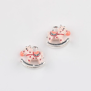 Detailed close-up of pink alloy rocking horse pendants for DIY jewelry crafting