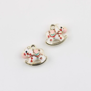 Detail of colorful enamel rocking horse pendants with gold metal frames for DIY jewelry