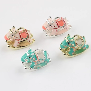 Detailed view of colorful enamel rocking horse pendants with star patterns for DIY jewelry