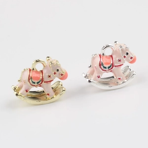 Detail of pink enamel rocking horse charms in gold and silver plating for DIY jewelry