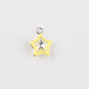 Macro detail of yellow enamel star pendant with silver metallic base for DIY jewelry