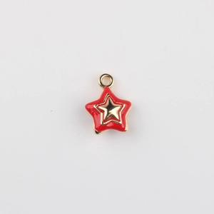 Detail showing red enamel star pendant with gold alloy trim and integrated hanging loop