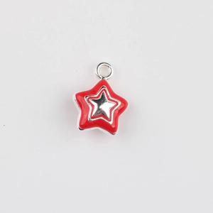 Detail of red enamel star pendant charm with silver metal edges for DIY jewelry making