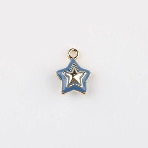 Detail of blue enamel star pendant with gold metal trim and integrated hanging loop