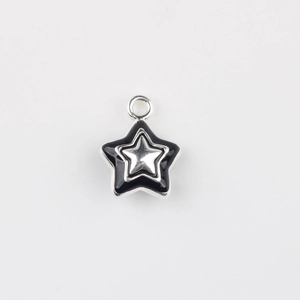 Detail of silver alloy star pendant with black enamel inlay and metal loop for DIY jewelry