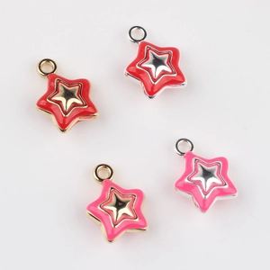 Close-up of red and pink enamel star charms with gold and silver alloy plating