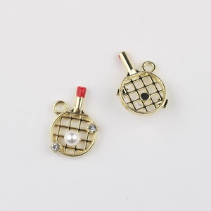 Macro view of gold-plated racket charms with pearls and zircons for DIY jewelry making