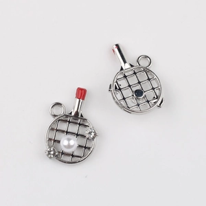 Detailed macro view of alloy ping pong racket pendants with white pearls and rhinestones